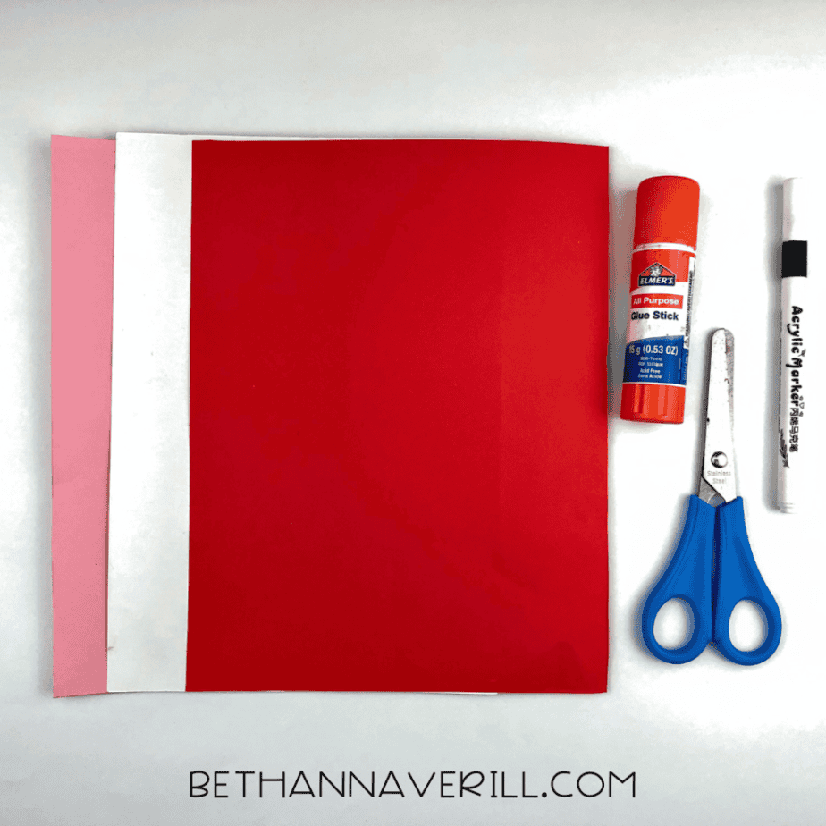 Heart fish supplies: red, pink and white paper, glue stick, marker and scissors