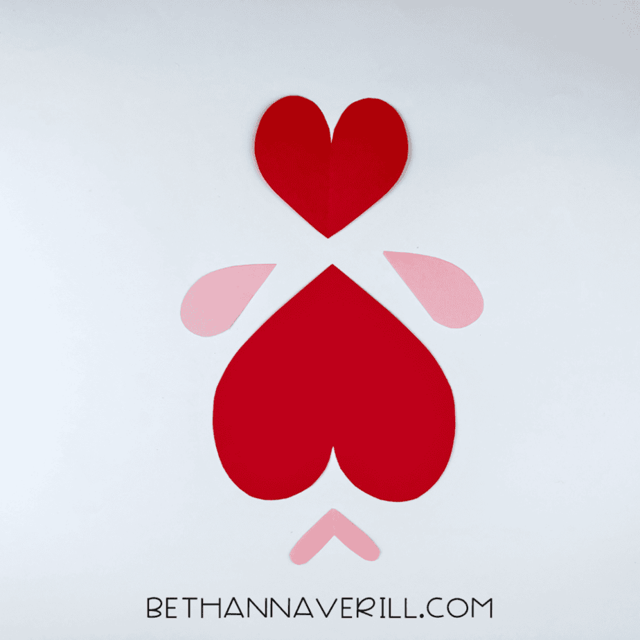 Red paper hearts and pink fins cut out