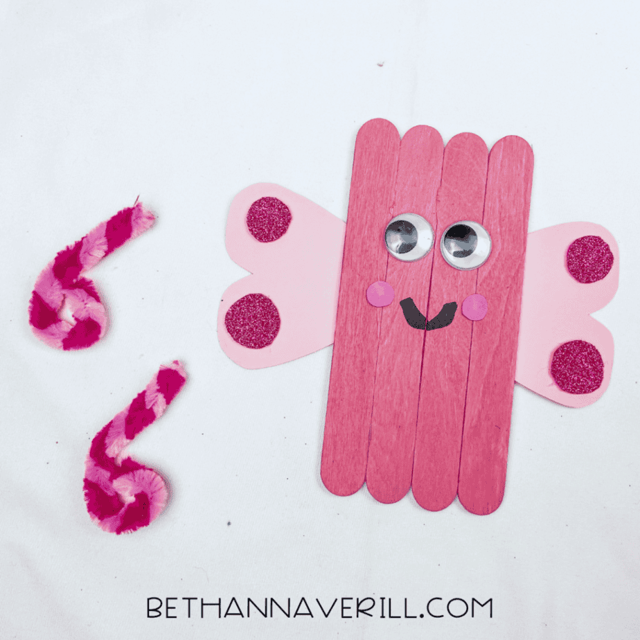 Curled pipe cleaner antennae next to the love bug