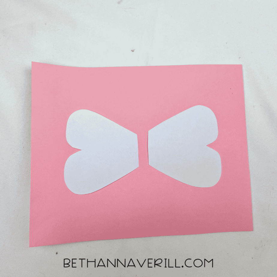 Wing shapes traced on pink paper