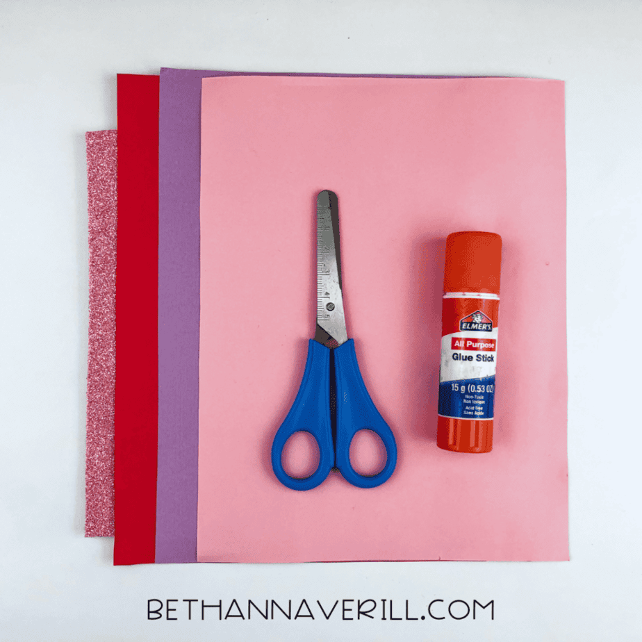 Valentine owl supplies: purple, pink and red paper, glue stick and scissors