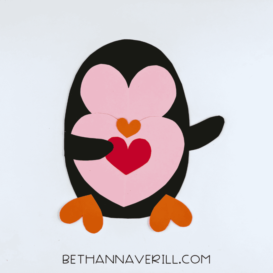 Black arms and red heart added to the penguin