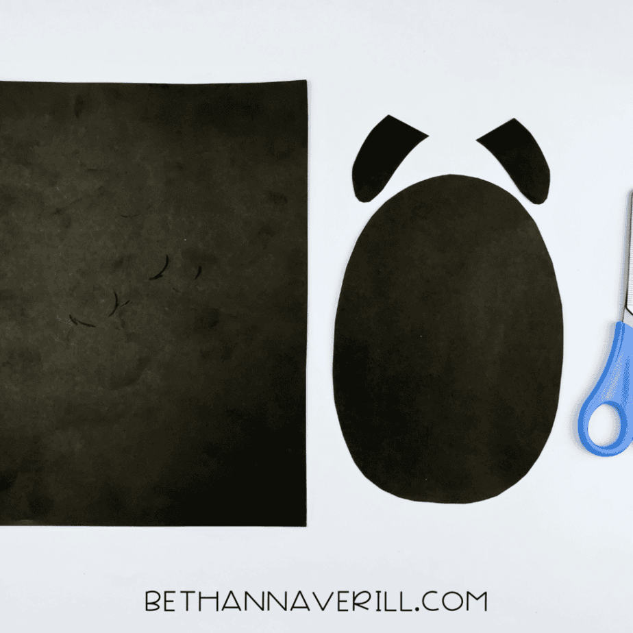 Black paper oval body and arms cut out