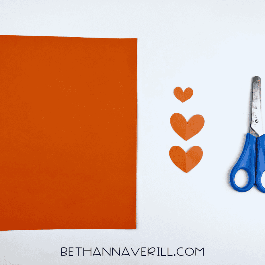 Small orange paper hearts cut out