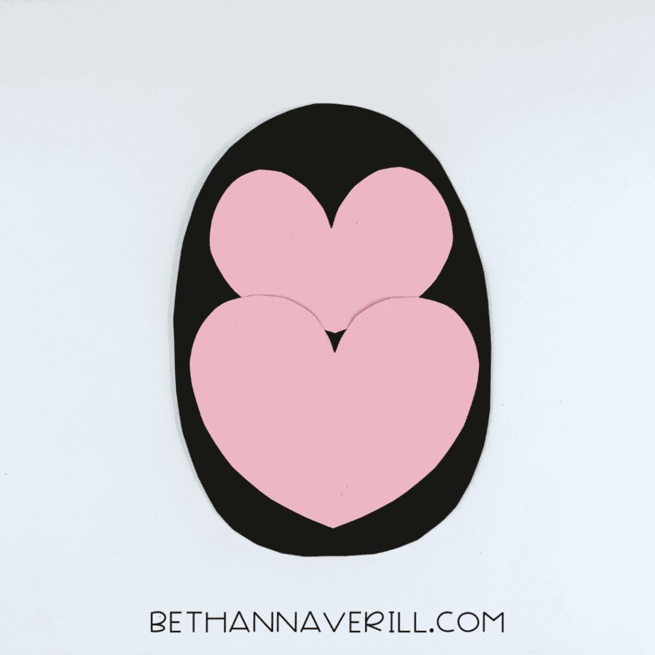 Pink heart belly and face glued onto the black oval