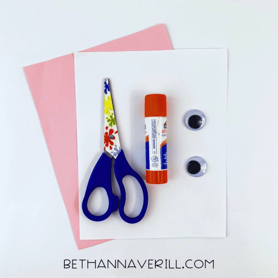 Valentine turtle supplies: pink and purple paper, googly eyes, glue stick and scissors