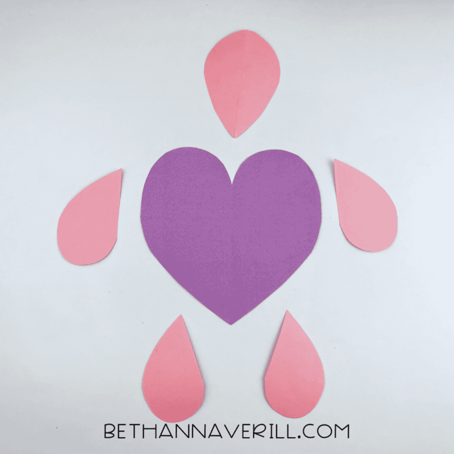 Teardrop head and legs arranged around the purple heart