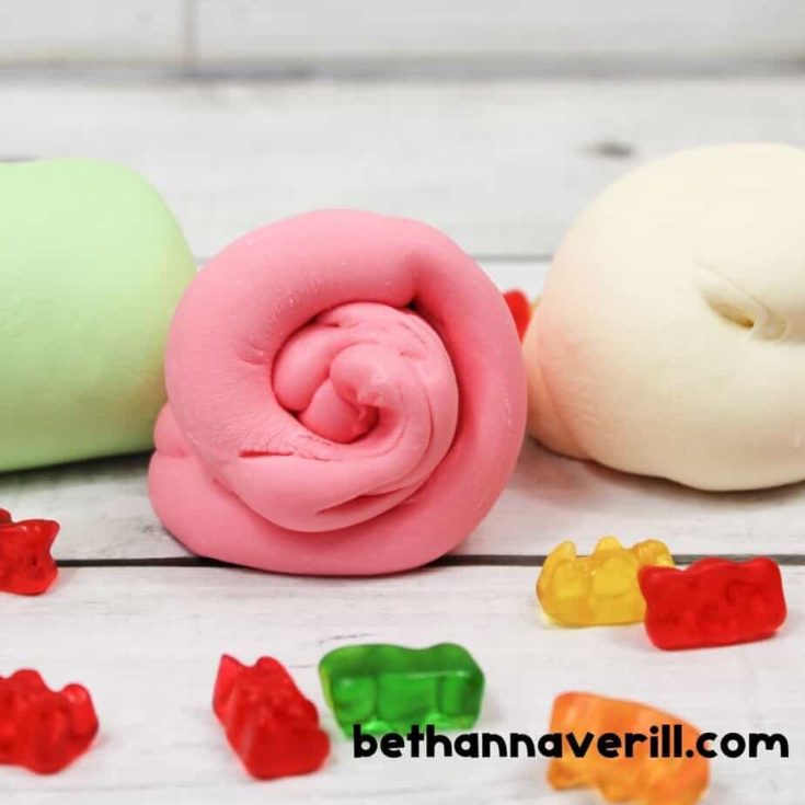 Three rolled balls of slime in pink, green, and white are displayed side by side, with gummy bears scattered around on a wooden surface. Text “bethannaverill.com” is visible below.