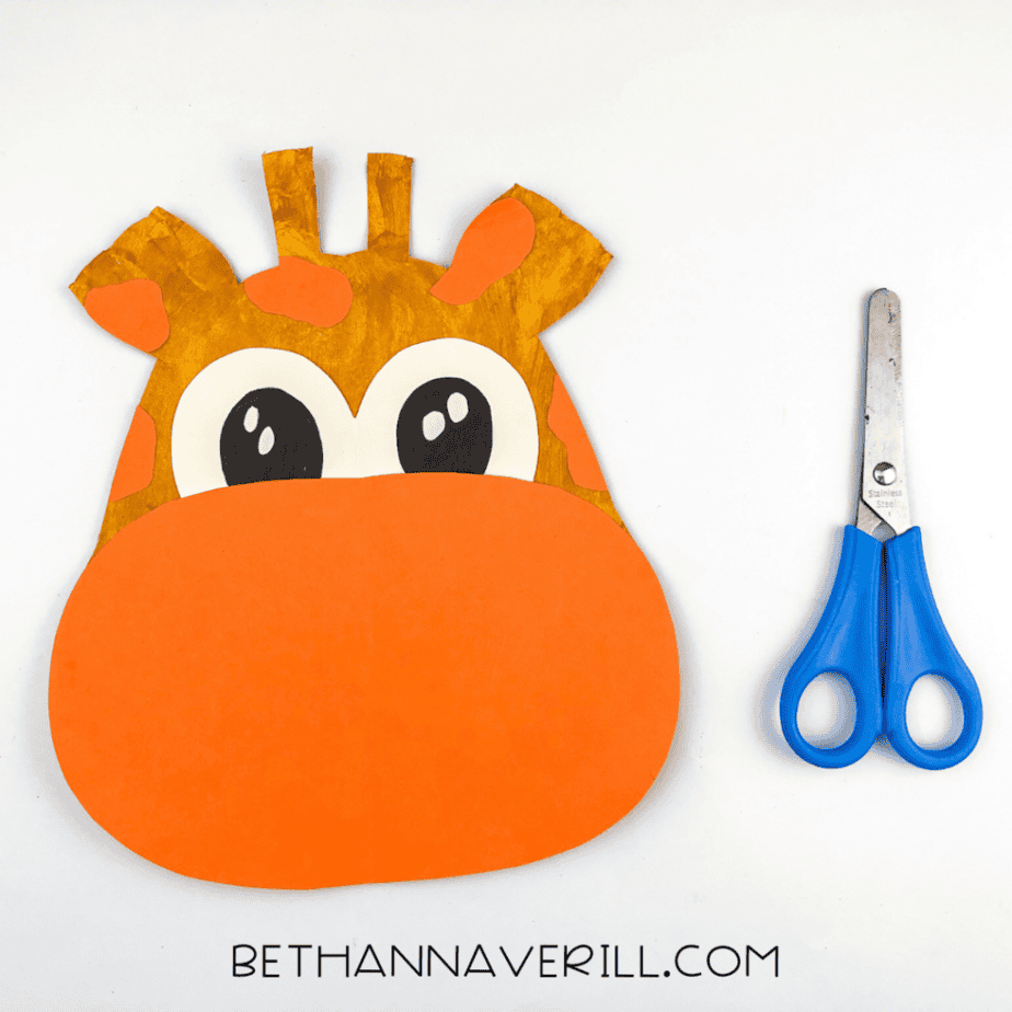 Orange spots trimmed down to fit the giraffe’s head and ears, surrounding the eyes.