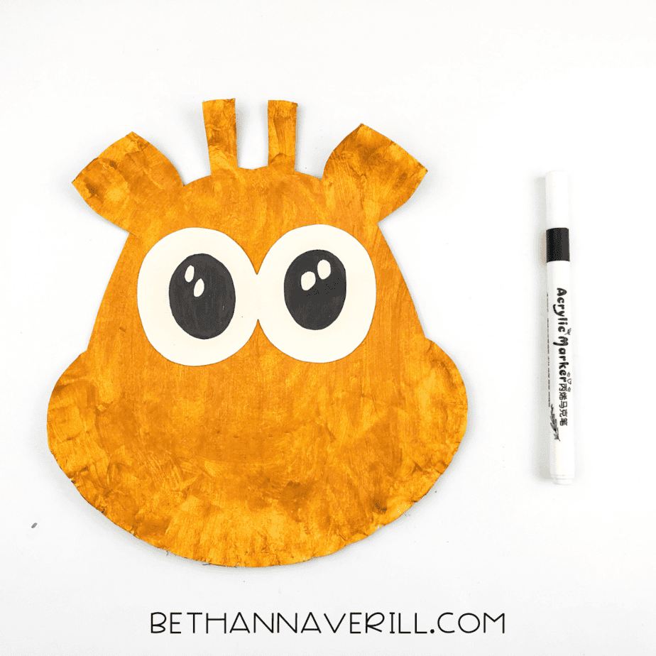 Black pupils and highlights drawn onto the cream eyes using a marker.