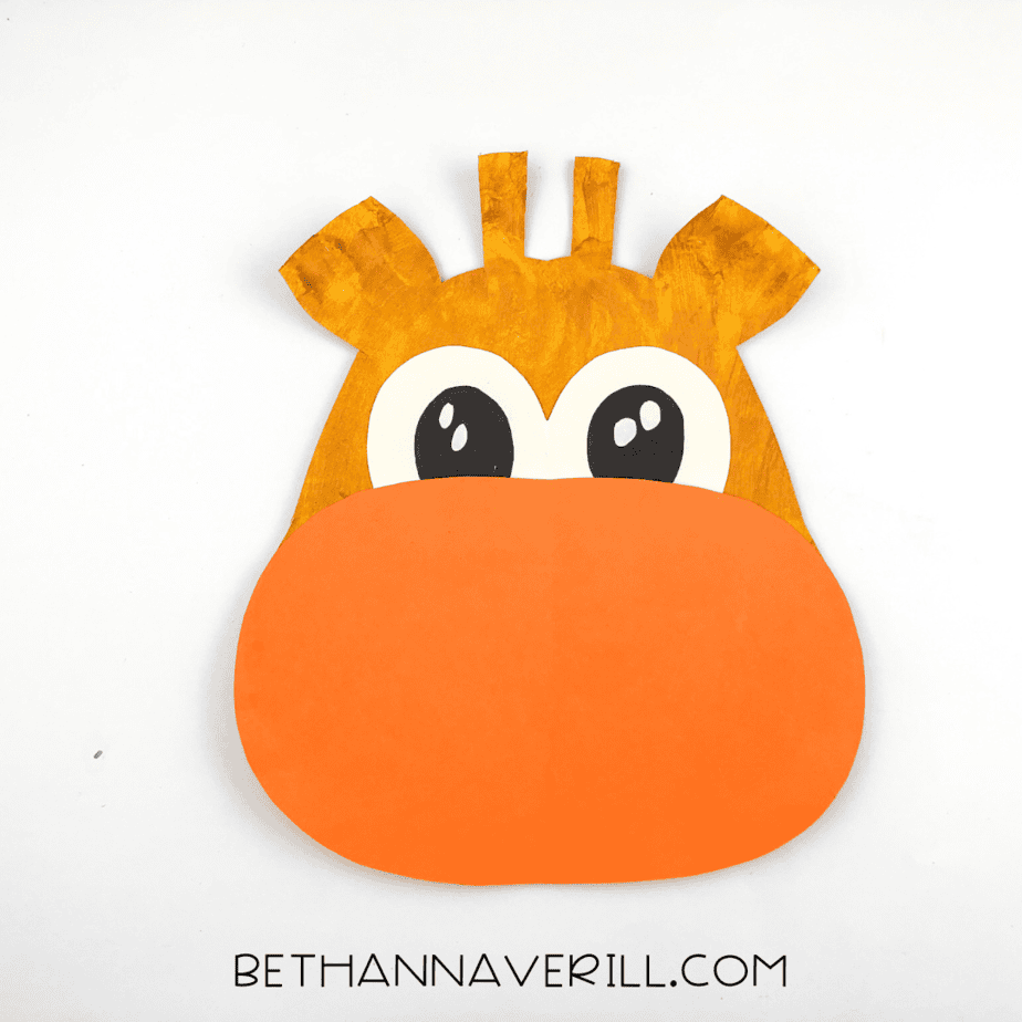 A large orange muzzle shape glued to the bottom of the giraffe’s face.