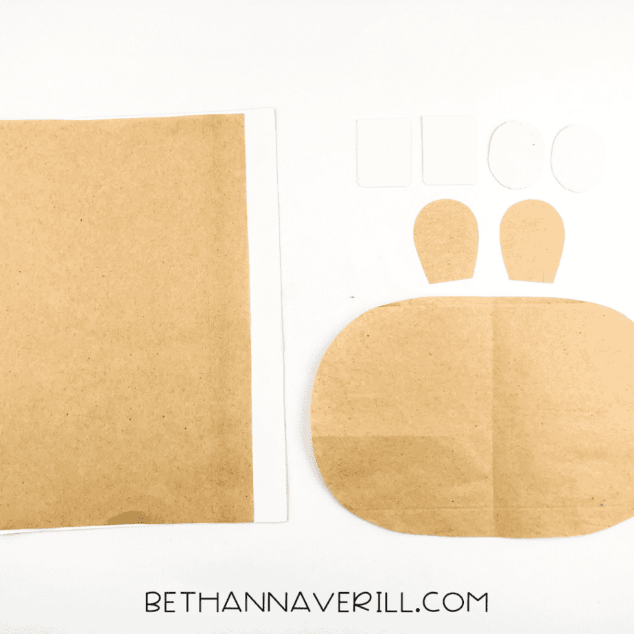 Brown and white paper pieces cut out for the hippo’s face: muzzle, ears, eyes, and teeth.