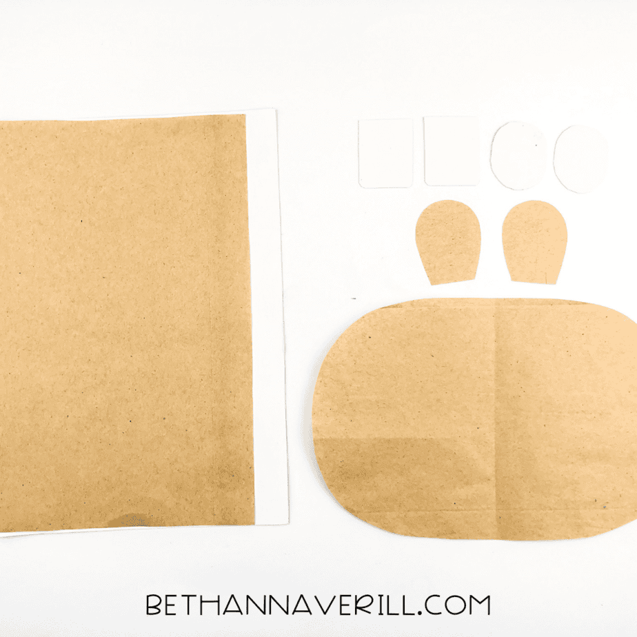 Brown and white paper pieces cut out for the hippo’s face: muzzle, ears, eyes, and teeth.