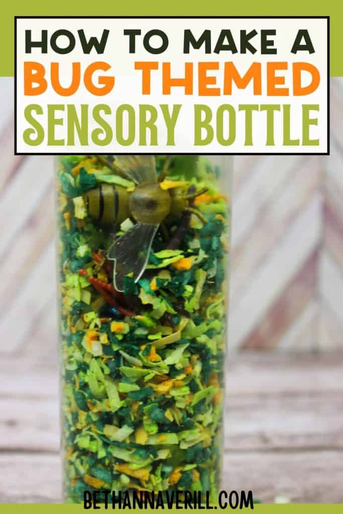 A tall sensory bottle packed with green, yellow, and orange shredded filler and bug toys like a bee and worms. Text at the top reads, “How to Make a Bug Themed Sensory Bottle,” and “bethannaverill.com” appears at the bottom in bold black letters.