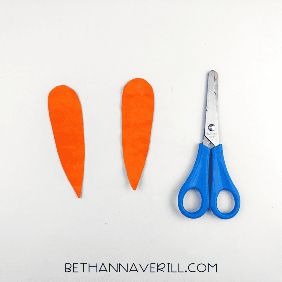 Two long, narrow orange ears cut from the paper plate