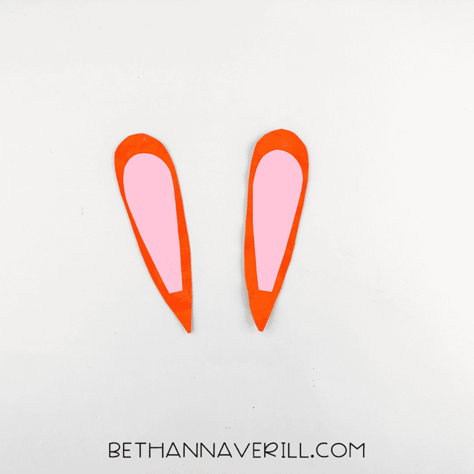 Pink inner ears glued onto the orange outer ear pieces