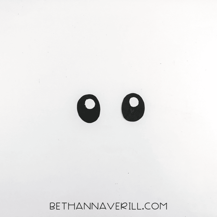 Two black oval eyes with white dot highlights ready to be added.