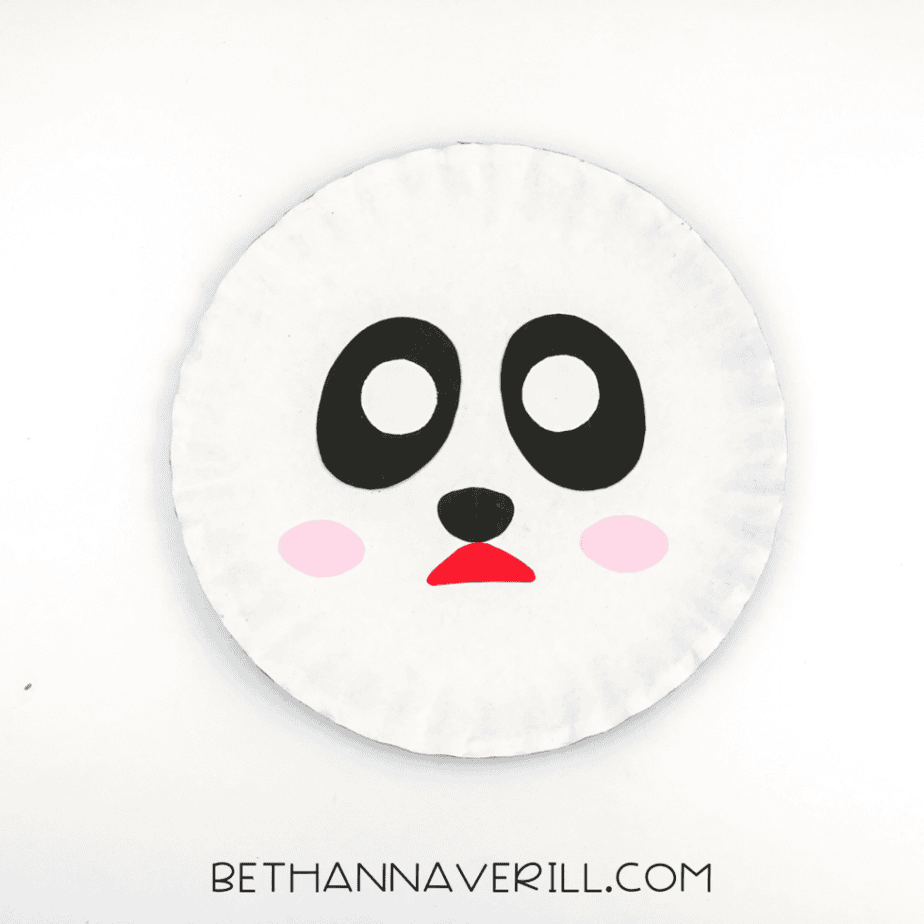 Pink circles glued to the left and right of the panda's face, next to the nose and mouth.