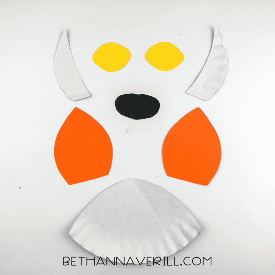 Tiger pieces cut from paper: ears, inner ears, yellow eyes, black nose and white snout