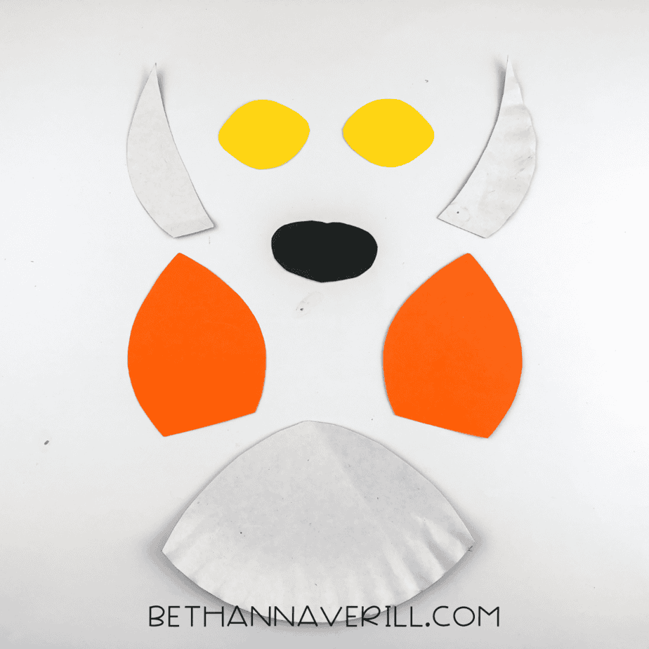 Paper plate cut out of orange and black paper.