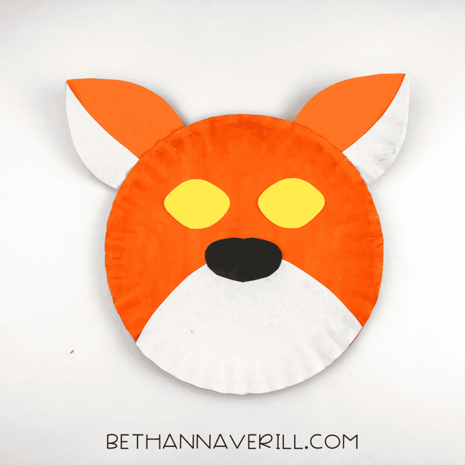 Paper plate tiger with eyes and nose.