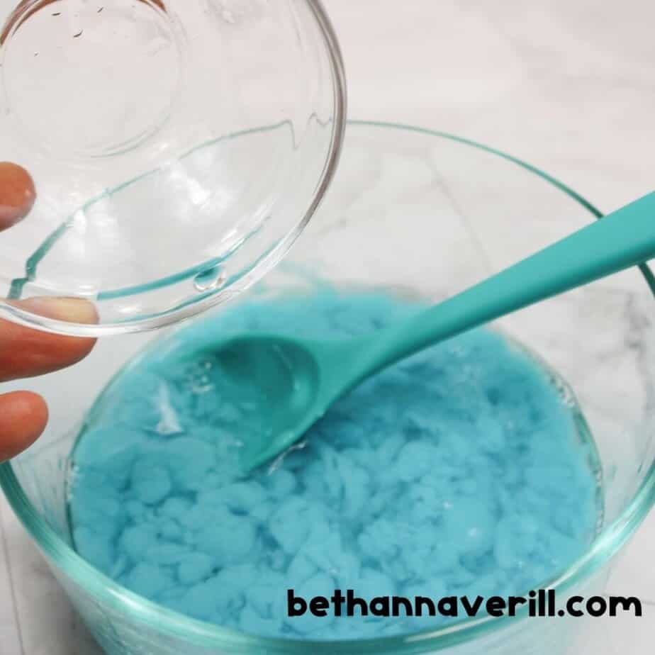Blue slime pulling together on a spoon