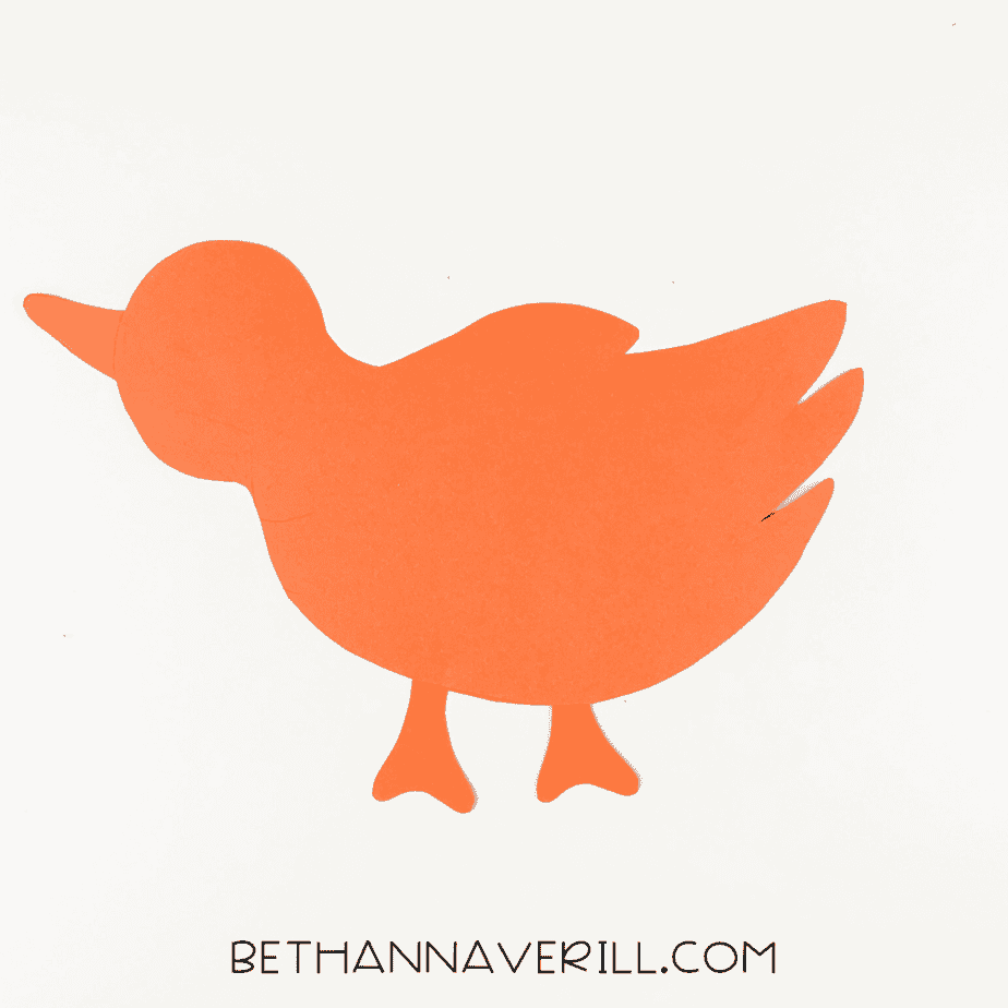 Orange bird base assembled with beak and legs.