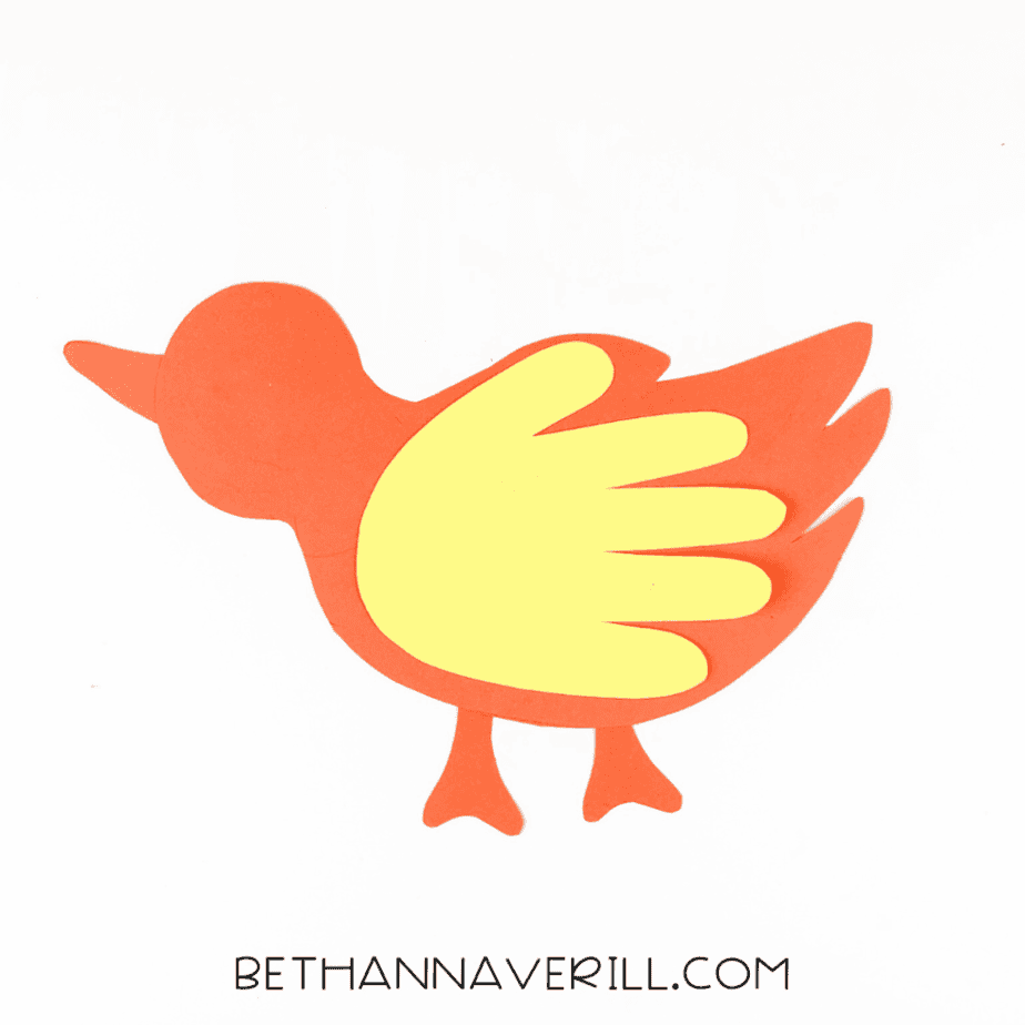 Yellow handprint glued on as the wing.