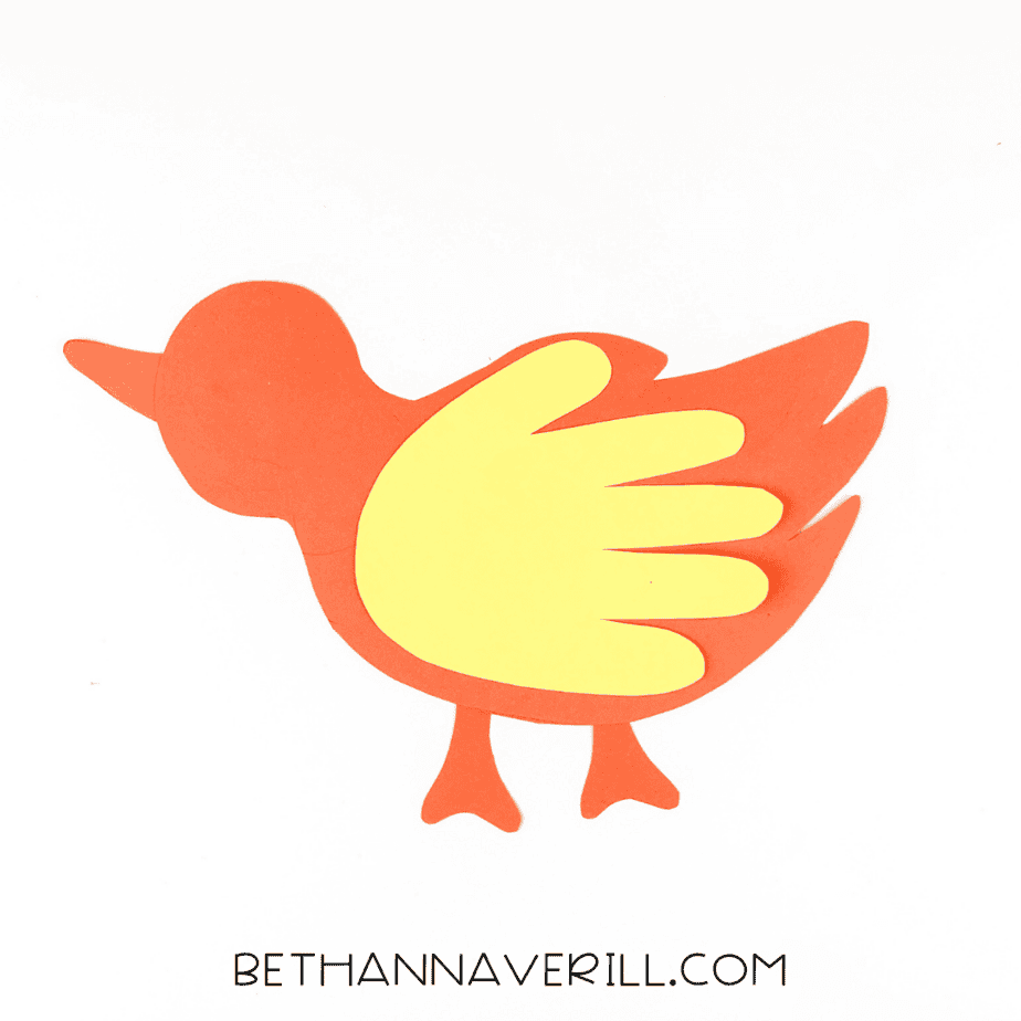 Yellow handprint glued on as the wing.