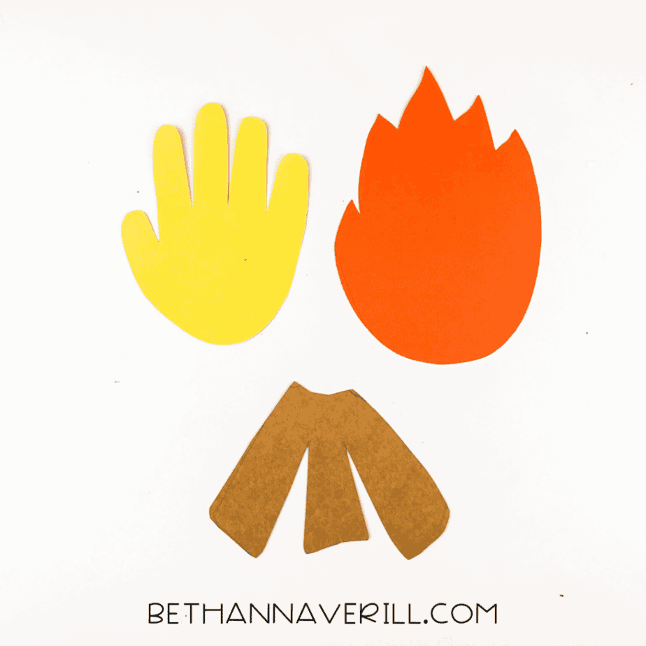 Cut-out shapes for the bonfire craft: a yellow handprint, an orange flame, and three brown paper logs.