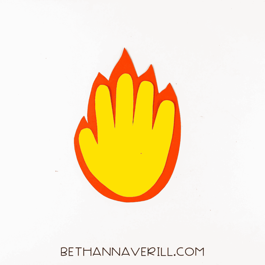 The yellow handprint glued on top of the orange flame cutout.
