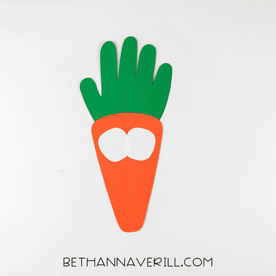 Two white eyes glued to the center of the carrot