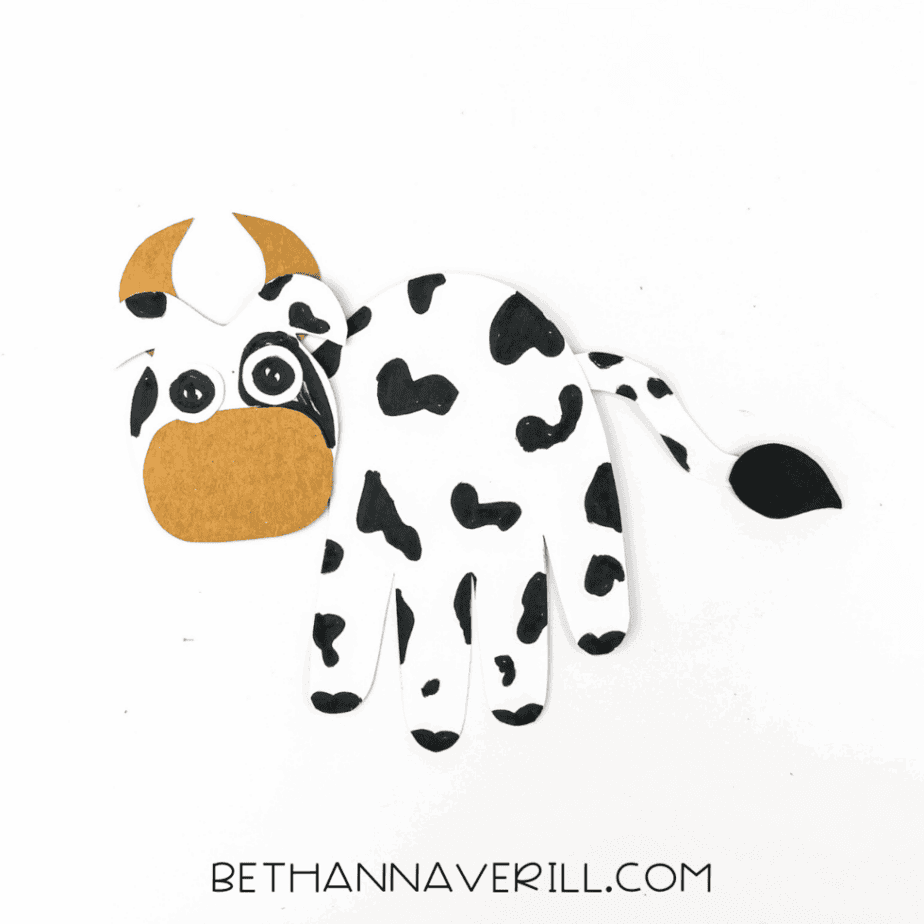 cow handprint craft fully assembled with tail and head attached.