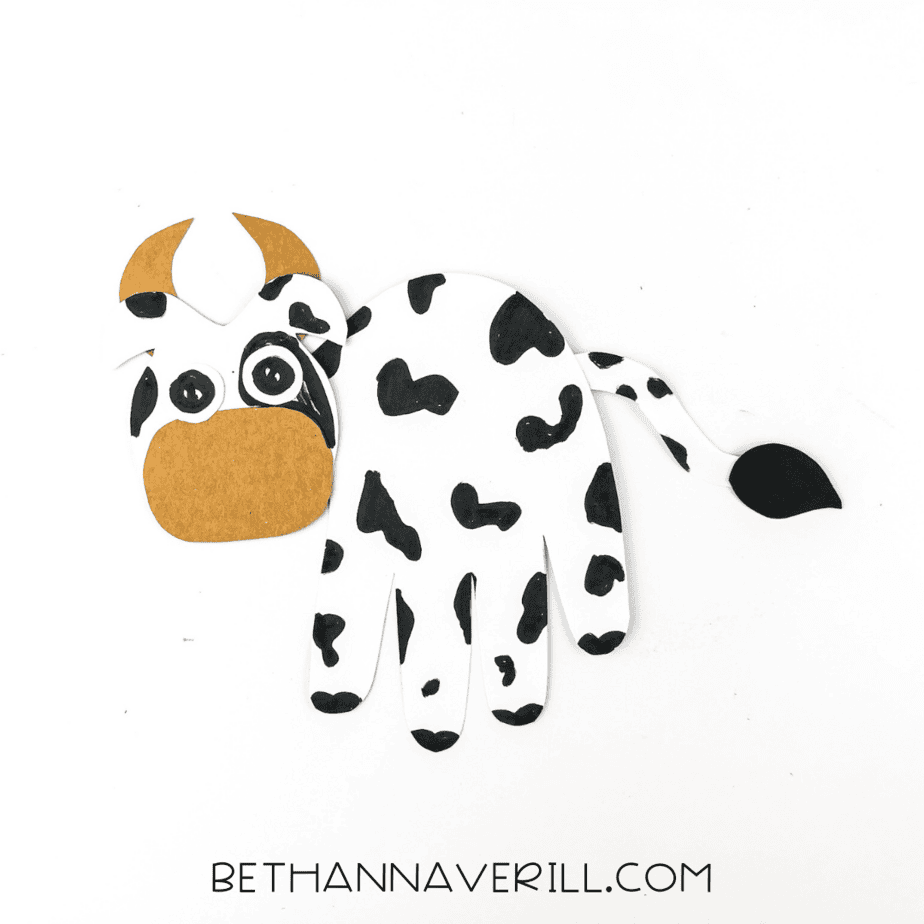 cow handprint craft fully assembled with tail and head attached.