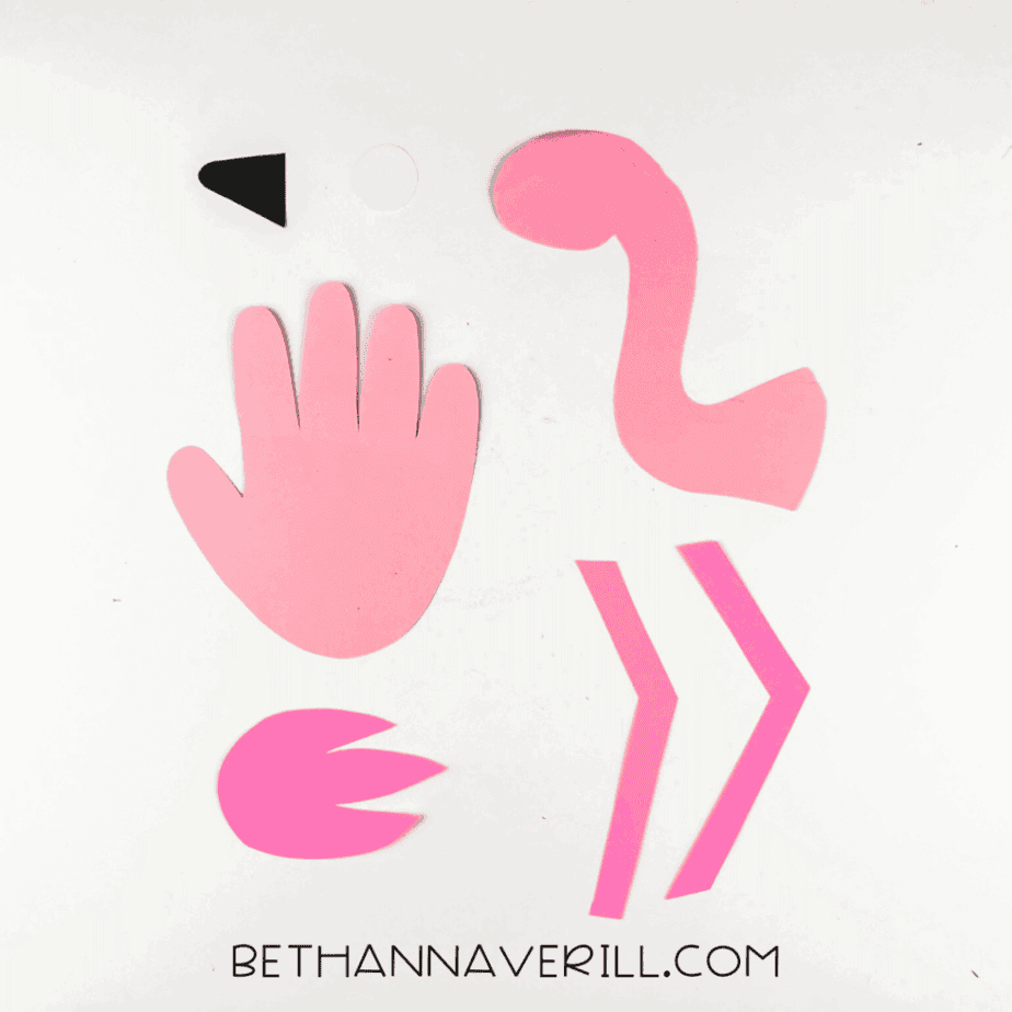 All flamingo parts cut out: handprint body, neck, beak, eye, wing, and legs.