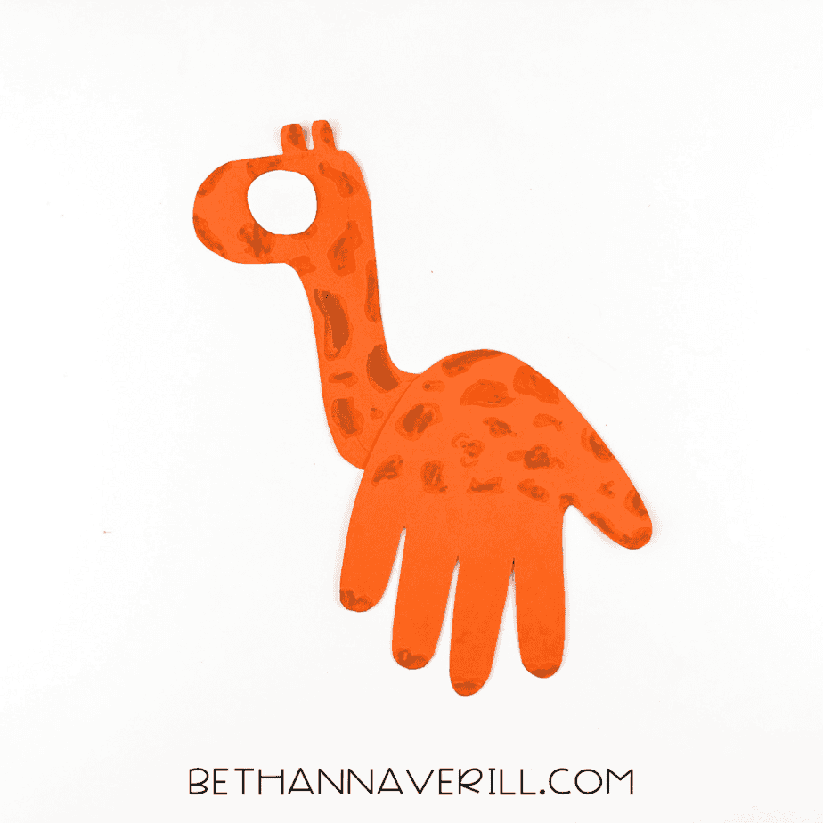 Giraffe craft with white eye circle glued in place.