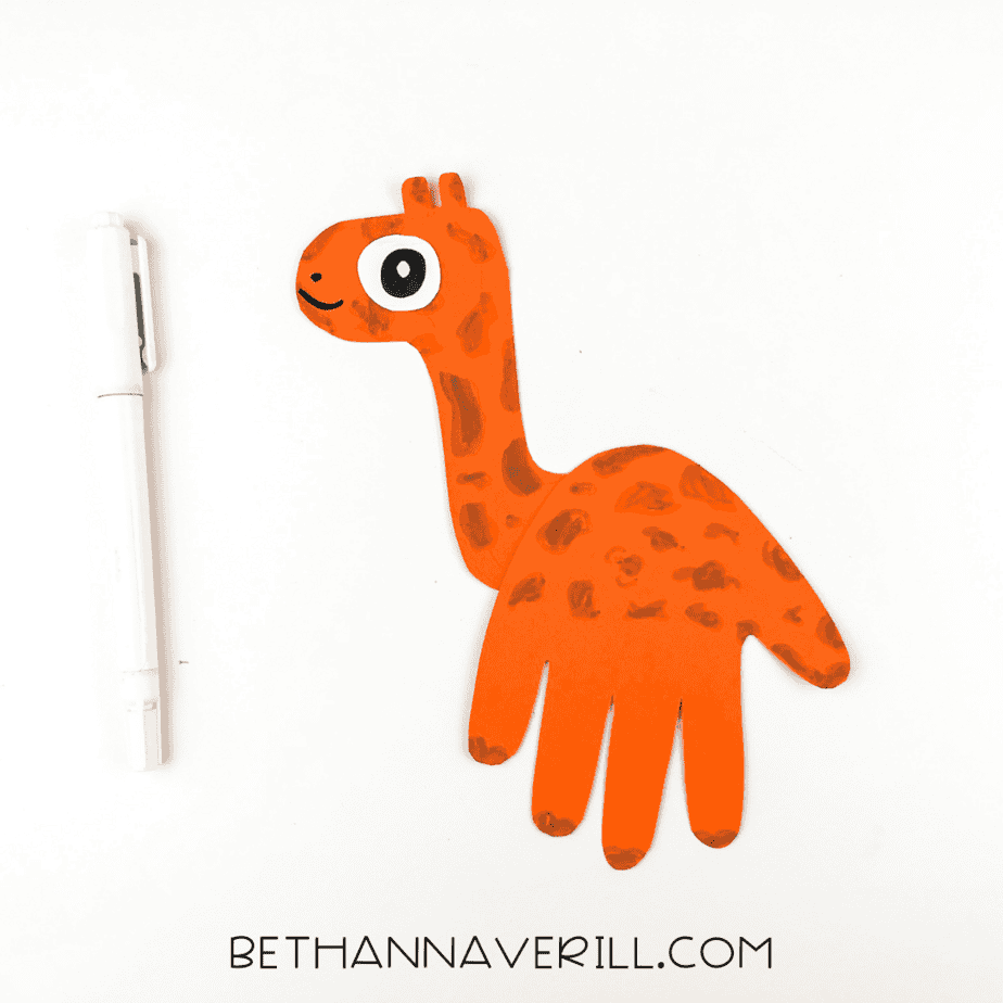 Giraffe handprint with face details and finished eye added.