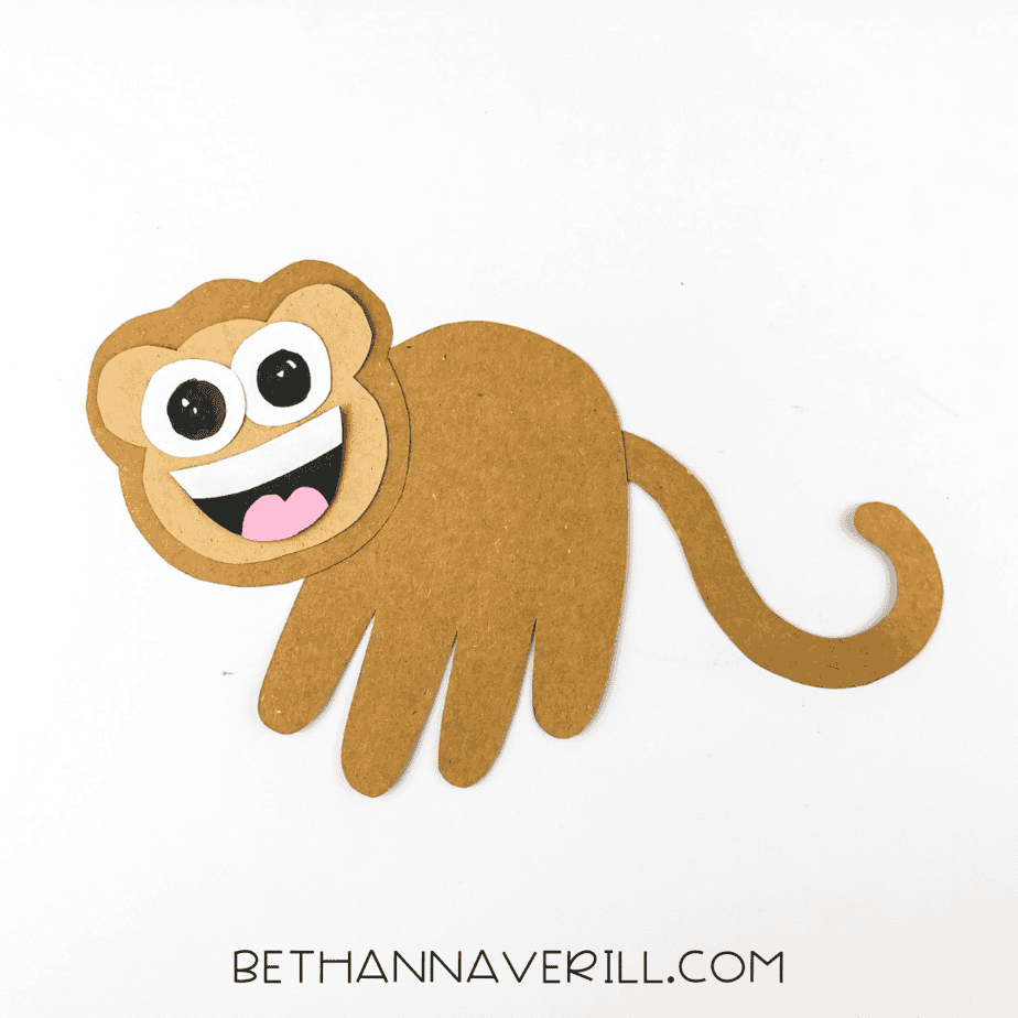 Completed monkey handprint craft shown on white background.