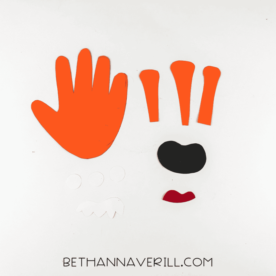 All monster craft pieces cut out: handprint, eyes, arms, teeth, tongue, mouth.