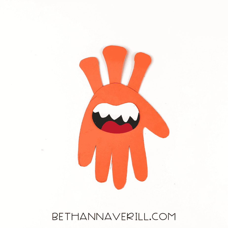 Handprint with monster mouth glued in place.