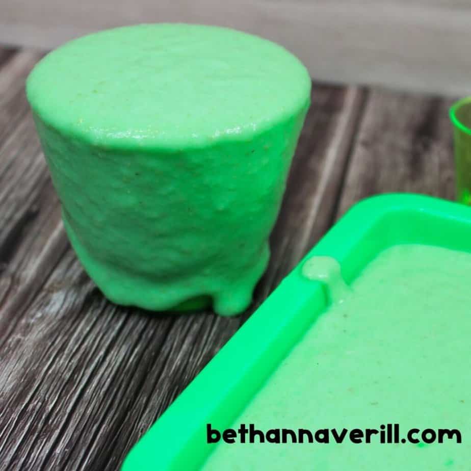 Nickelodeon-themed slime in a cup and tray, showing the thick, green, gooey consistency with bethannaverill.com watermark.