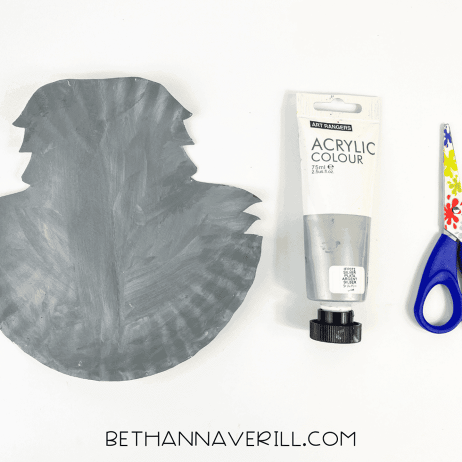 Paper plate painted grey with acrylic paint, ready for the baboon craft.