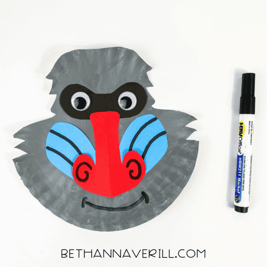 Baboon paper plate craft with extra details drawn in black marker on the nose and cheeks.