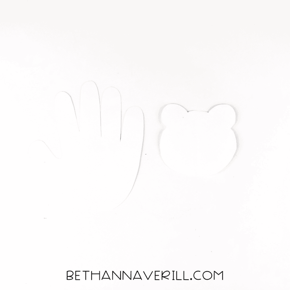 Cut out white handprint and a white circle head with ears