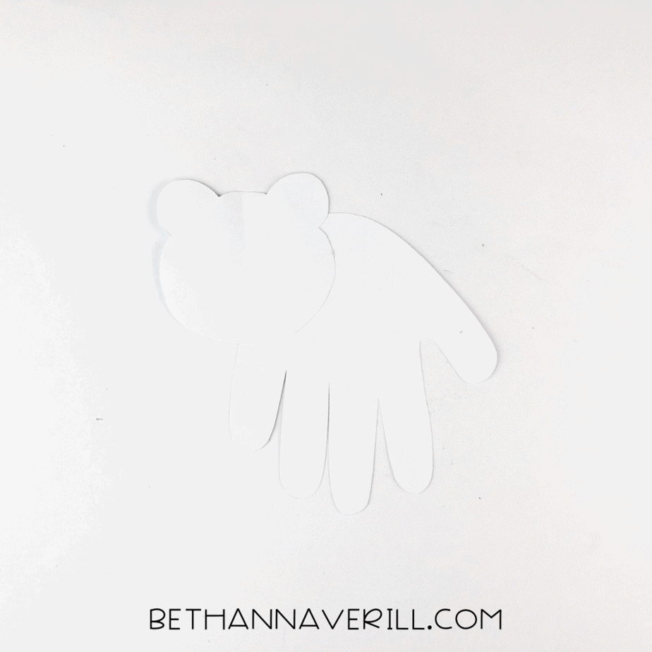 Polar bear head glued onto the side of the white handprint