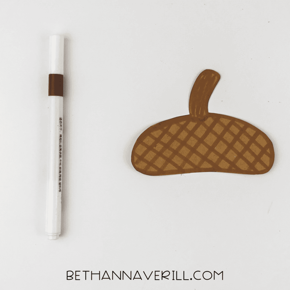 Brown marker used to decorate the acorn cap with a criss-cross pattern.