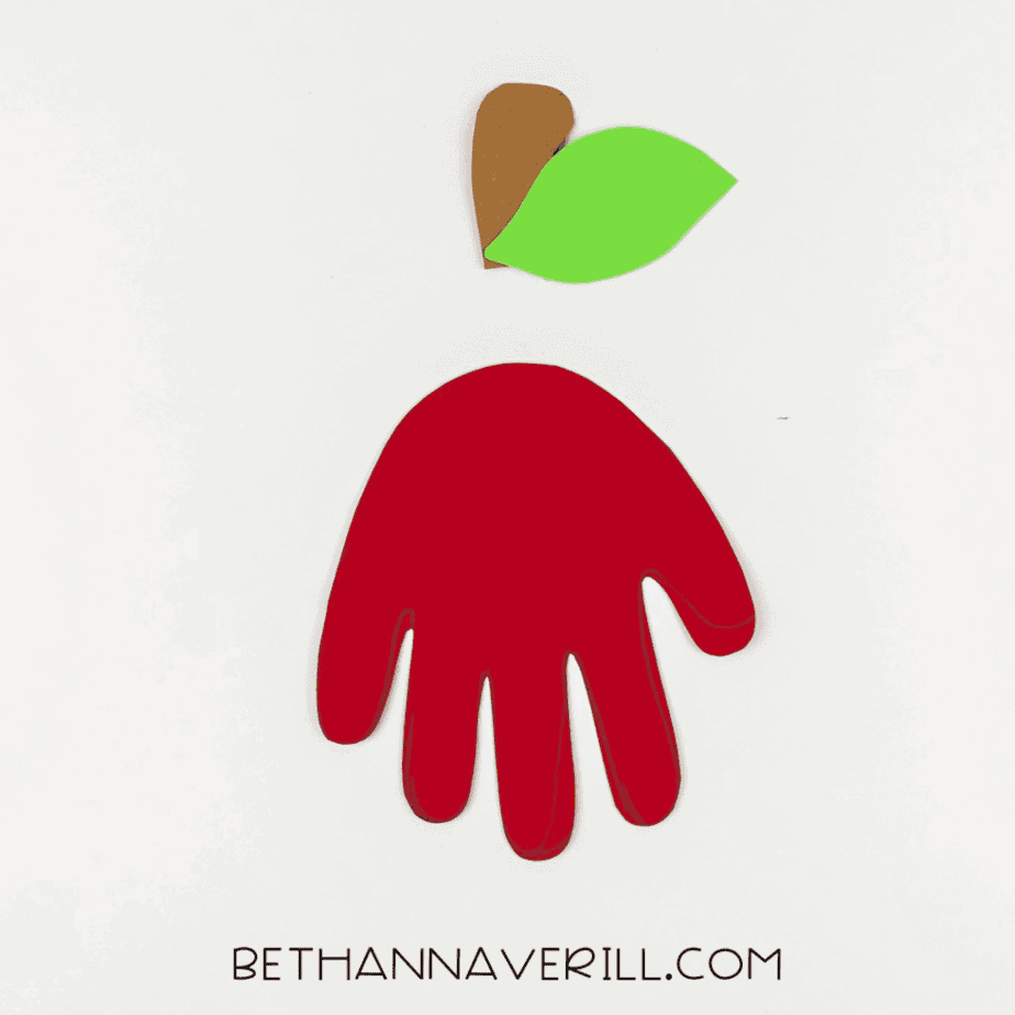 Leaf and stem positioned above the red handprint.