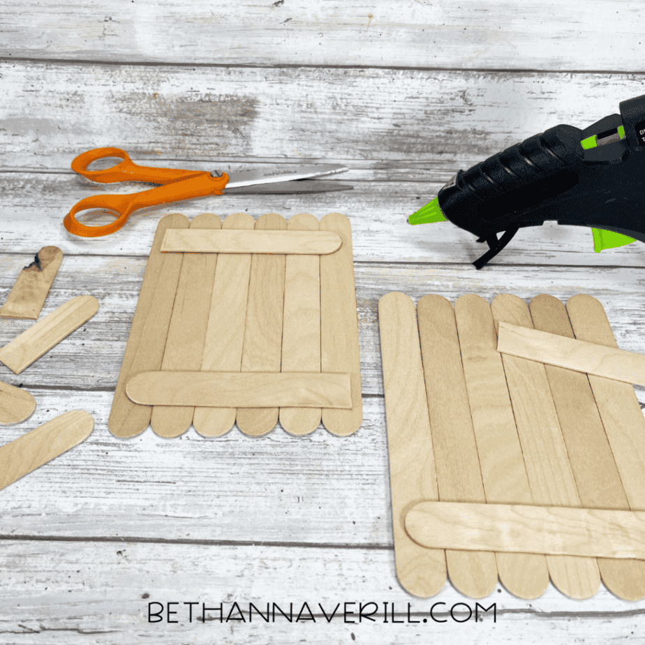 Wooden craft sticks glued together with support sticks across the back.