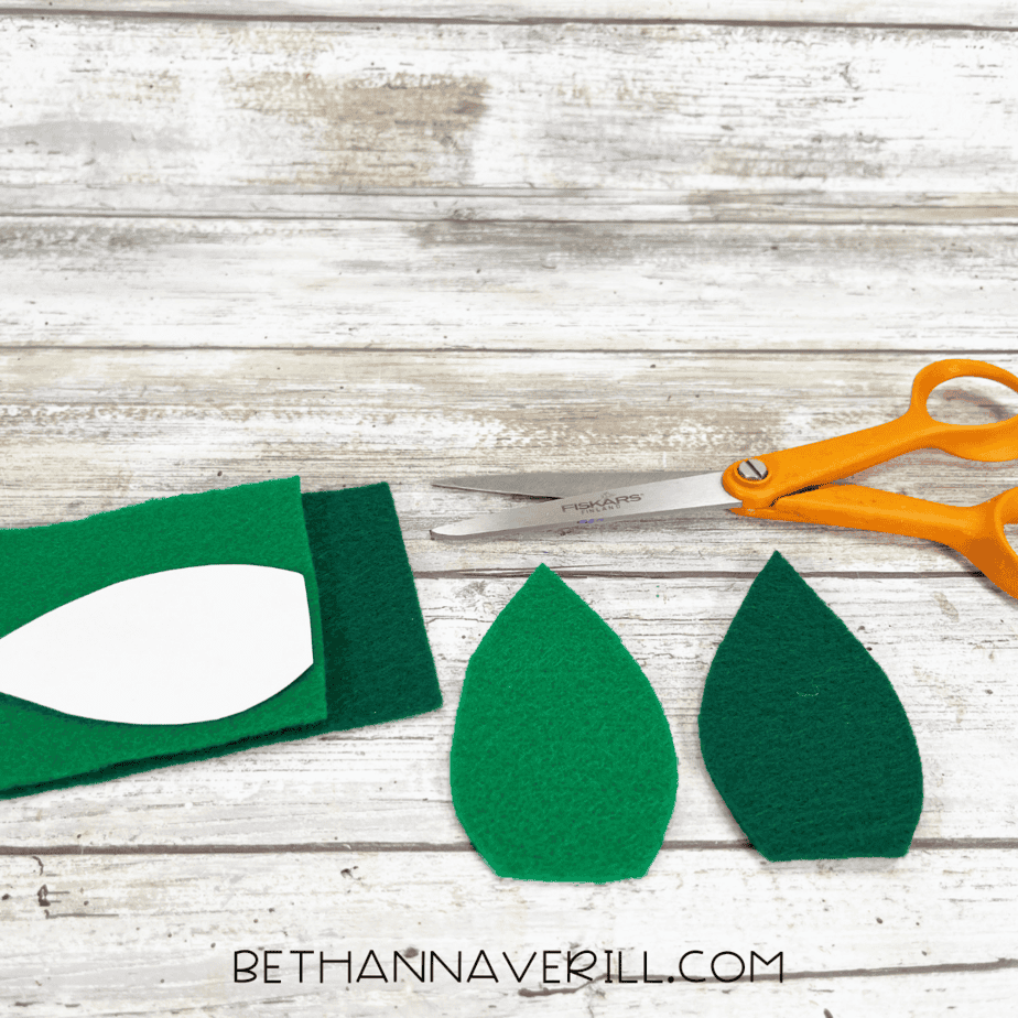 Green felt with leaf template traced and cut out.
