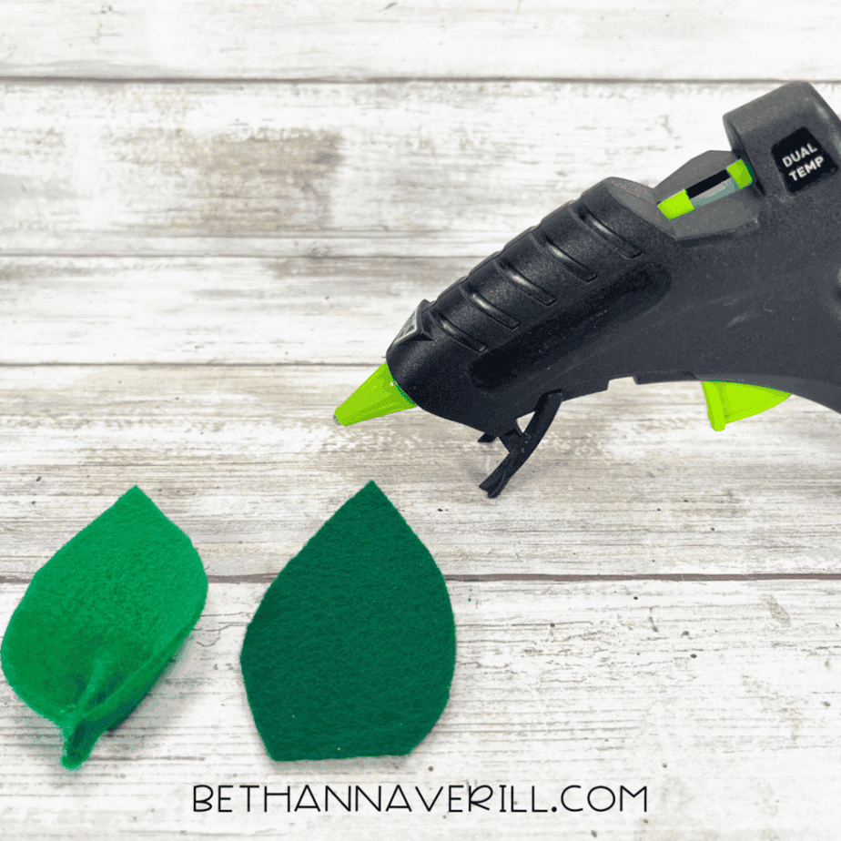 Two green felt leaves, one pinched and glued for shape.